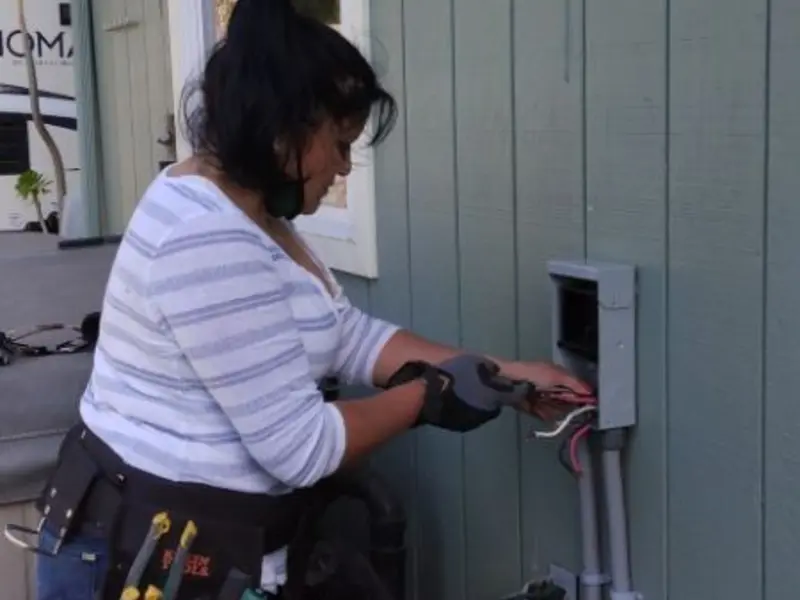 Licensed electrician wiring an exterior subpanel in Lancaster
